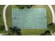Aerial view of a basketball court surrounded by green grass and walking paths at 4160 Pinelake Ln # 201, Tampa, FL 33618