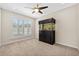 Neutral bedroom featuring a large aquarium, ceiling fan, and bright natural light at 4160 Pinelake Ln # 201, Tampa, FL 33618
