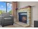 Modern stone fireplace with a warm hearth, complemented by natural light and comfortable seating at 4160 Pinelake Ln # 201, Tampa, FL 33618