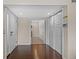 Bright foyer with dark hardwood flooring, a coat closet, and entrance into the carpeted living area at 4160 Pinelake Ln # 201, Tampa, FL 33618