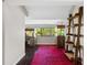 Hallway features striking red rug, modern shelving, and large aquariums with beautiful backyard views at 4160 Pinelake Ln # 201, Tampa, FL 33618