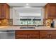 Kitchen features a tiled backsplash, a granite countertop and a stainless steel sink at 4160 Pinelake Ln # 201, Tampa, FL 33618