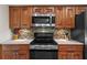 Modern kitchen features stainless steel appliances, granite countertops, and wooden cabinetry at 4160 Pinelake Ln # 201, Tampa, FL 33618