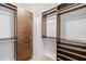Spacious walk-in closet providing ample storage with custom shelving and cabinetry at 4160 Pinelake Ln # 201, Tampa, FL 33618