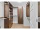 Walk-in closet with custom built-in shelving and storage system at 4160 Pinelake Ln # 201, Tampa, FL 33618
