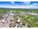 Aerial shot highlights the property near water, with street access and parking amongst lush trees in an active commercial district at 4207 W San Rafael St # E, Tampa, FL 33629