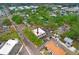 Aerial view of a two-story commercial building with ample parking surrounded by mature trees in a vibrant urban setting at 4207 W San Rafael St # E, Tampa, FL 33629