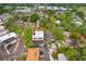 Aerial view showcases a two-story building with street access and parking, enveloped by green trees in an urban neighborhood at 4207 W San Rafael St # E, Tampa, FL 33629