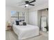 Comfortable bedroom features a ceiling fan, a big window, and modern décor at 4207 W San Rafael St # E, Tampa, FL 33629