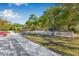 Community playground area featuring a modern playset and picnic shelter, surrounded by mature trees in a grassy area at 4315 70Th E Ave, Ellenton, FL 34222