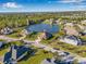 Wide aerial view of a lakeside home in a residential neighborhood with lush landscaping and nearby amenities at 4315 70Th E Ave, Ellenton, FL 34222