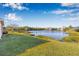 Expansive backyard featuring a picturesque view of a calm lake surrounded by mature trees at 4315 70Th E Ave, Ellenton, FL 34222