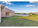 Spacious backyard with lush green grass and a scenic view of the tranquil lake at 4315 70Th E Ave, Ellenton, FL 34222
