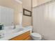 Functional bathroom with a single sink vanity, framed mirror, and a shower/tub combination with a decorative curtain at 4315 70Th E Ave, Ellenton, FL 34222