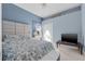 Comfortable bedroom with a stylish upholstered headboard, patterned bedding, and bright natural light from the window at 4315 70Th E Ave, Ellenton, FL 34222