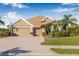 Inviting single-story home with a three-car garage, brick driveway, and neatly manicured landscaping at 4315 70Th E Ave, Ellenton, FL 34222