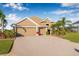 Beautiful single-story home with a three-car garage, paver driveway, and well-maintained lawn at 4315 70Th E Ave, Ellenton, FL 34222
