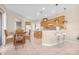 Open kitchen with wood cabinets, a breakfast bar, and dining area with natural light at 4315 70Th E Ave, Ellenton, FL 34222