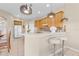 Bright kitchen with wooden cabinets, pendant lighting, and a breakfast bar with white stools at 4315 70Th E Ave, Ellenton, FL 34222