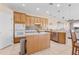 Spacious kitchen with an island, stainless steel appliances, and wooden cabinetry at 4315 70Th E Ave, Ellenton, FL 34222