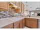 Kitchen with decorative tile backsplash, range, countertop, and wood cabinets at 4315 70Th E Ave, Ellenton, FL 34222
