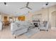 Open-concept living room featuring a fireplace, comfortable seating, and seamless access to the dining area and kitchen at 4315 70Th E Ave, Ellenton, FL 34222