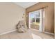 Cozy sitting area with a recliner, window views to the outdoors, and a storage shelf for decorations and books at 4315 70Th E Ave, Ellenton, FL 34222