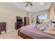 Spacious main bedroom features tile flooring, neutral decor, and a window providing a view of the backyard landscape at 4315 70Th E Ave, Ellenton, FL 34222