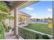 Serene screened patio with a tranquil view of the pond and well-manicured backyard at 4315 70Th E Ave, Ellenton, FL 34222
