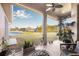 Relaxing screened patio with a ceiling fan overlooking a serene pond view and lush landscaping at 4315 70Th E Ave, Ellenton, FL 34222