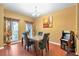 Elegant dining room boasting a modern light fixture, dining table and a quirky PacMan arcade console at 5831 Leopardstown Dr, Tampa, FL 33610