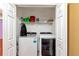 Laundry room with side-by-side washer and dryer, shelving, and cleaning supplies at 5831 Leopardstown Dr, Tampa, FL 33610