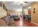 Spacious living room featuring hard wood floors, comfortable seating, and a bar overlooking the kitchen at 5831 Leopardstown Dr, Tampa, FL 33610