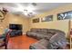 Comfortable living room with a ceiling fan, entertainment center, and a large sectional sofa at 5831 Leopardstown Dr, Tampa, FL 33610