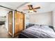 This bedroom boasts a ceiling fan and wood sliding doors to the en suite bathroom at 647 Yawl Ln, Palm Harbor, FL 34683