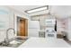 Efficient kitchen with modern appliances, stylish backsplash, and a unique barn door at 647 Yawl Ln, Palm Harbor, FL 34683