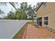 Large fenced backyard with a concrete patio featuring a fire pit at 6930 Summer Harbor Ln, Riverview, FL 33578
