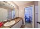 Neutral bathroom with a granite sink, cabinets and access to the shower at 6930 Summer Harbor Ln, Riverview, FL 33578
