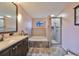 Well-lit bathroom features a dual sink vanity, separate shower, and soaker tub with tile surround at 6930 Summer Harbor Ln, Riverview, FL 33578