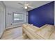 Bedroom with hardwood-style floors, bright window, and custom built-in desk at 6930 Summer Harbor Ln, Riverview, FL 33578