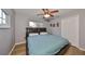 A cozy bedroom features wood-look flooring, a ceiling fan, and a double-door closet at 6930 Summer Harbor Ln, Riverview, FL 33578