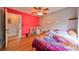 Bright bedroom features a colorful accent wall and wood-look flooring at 6930 Summer Harbor Ln, Riverview, FL 33578