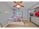 Cozy bedroom featuring wood-look flooring, closet, ceiling fan, and bright decor at 6930 Summer Harbor Ln, Riverview, FL 33578