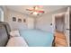 A comfortable bedroom features wood-look floors, a ceiling fan, and neutral walls at 6930 Summer Harbor Ln, Riverview, FL 33578