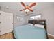 This bedroom features wood-look floors, a ceiling fan, and two large windows at 6930 Summer Harbor Ln, Riverview, FL 33578