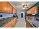 Bright kitchen features stainless steel appliances and beautiful wooden cabinetry at 6930 Summer Harbor Ln, Riverview, FL 33578