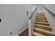 Modern staircase with wood steps and black railings leads to the upper level at 6930 Summer Harbor Ln, Riverview, FL 33578