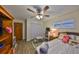 Cozy bedroom featuring a ceiling fan, wood-look floors, and closet at 727 Flamingo Dr, Apollo Beach, FL 33572
