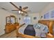 Bright bedroom with plank floors, ceiling fan, shuttered windows and furniture at 727 Flamingo Dr, Apollo Beach, FL 33572
