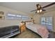 Cozy bedroom with wood floors, ceiling fan, and access to the pool area at 727 Flamingo Dr, Apollo Beach, FL 33572